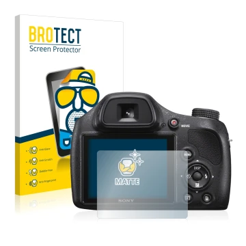 Front side of a product packaging with the brand logo BROTECT. Next to it is the device Sony Cyber-Shot DSC-H400 shown with th