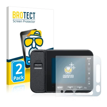 Front side of a product packaging with the brand logo BROTECT. Next to it is the device Sony DSC-RX0M2 (RX0 II) shown with the