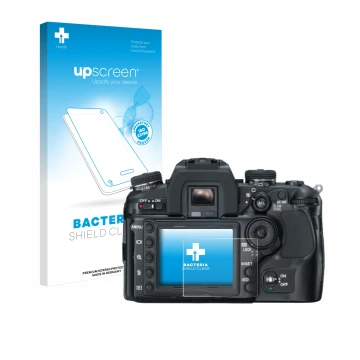 Front side of a product packaging with the brand logo upscreen. Next to it is the device Konica Minolta Dynax 7D shown with th