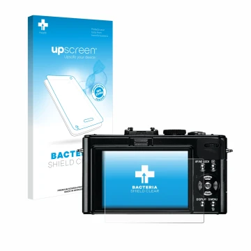 Front side of a product packaging with the brand logo upscreen. Next to it is the device Leica D-Lux 5 shown with the correspo