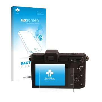 Front side of a product packaging with the brand logo upscreen. Next to it is the device Nikon 1 V1 shown with the correspondi