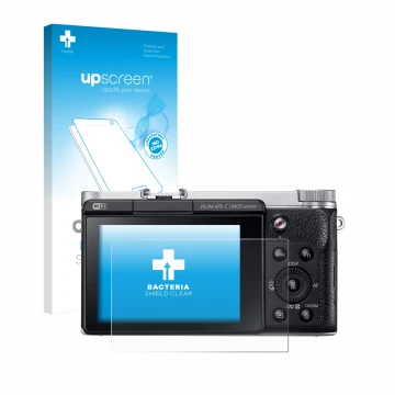 Front side of a product packaging with the brand logo upscreen. Next to it is the device Samsung NX300M shown with the corresp