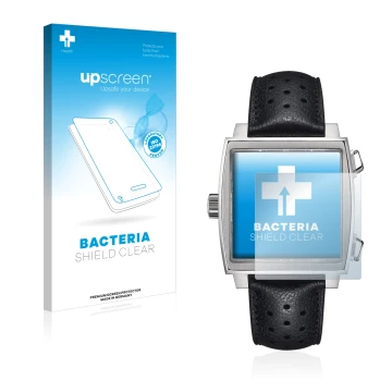 Front side of a product packaging with the brand logo upscreen. Next to it is the device TAG Heuer Monaco (39 mm) shown with t